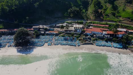 Aerial-view-of-fishing-boat-anchored-on-the-beach-with-sea-waves-reaching-the-coastline