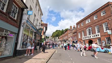 people walking near historic buildings and shops