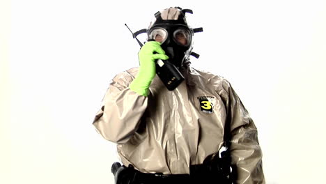 a man in a hazmat suit speaks into a walkietalkie