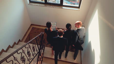 business team going up together in conference office on stairs