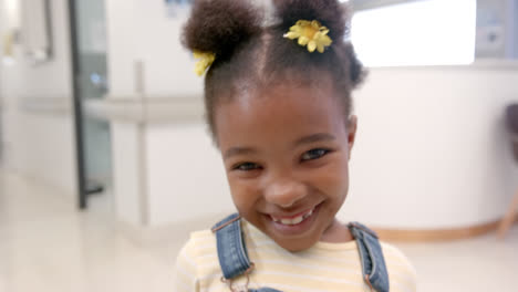 Portrait-of-happy-african-american-girl-in-hospital,-slow-motion