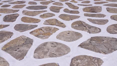 traditional cobblestone white painted pattern pavement found on many greek islands in the aegean sea