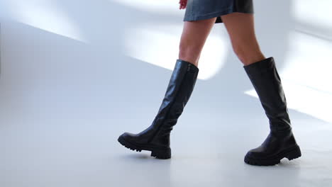 woman walking in stylish black leather platform boots