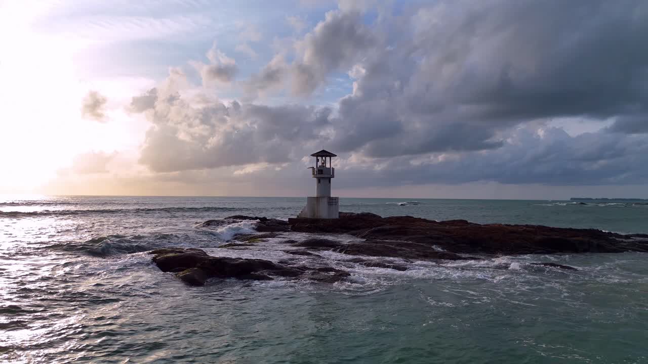 Lighthouse on rocky outcrop in the sea