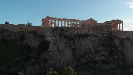 aerial footage of the acropolis in athens slowly revealing the city and the sea in the background, drone footage