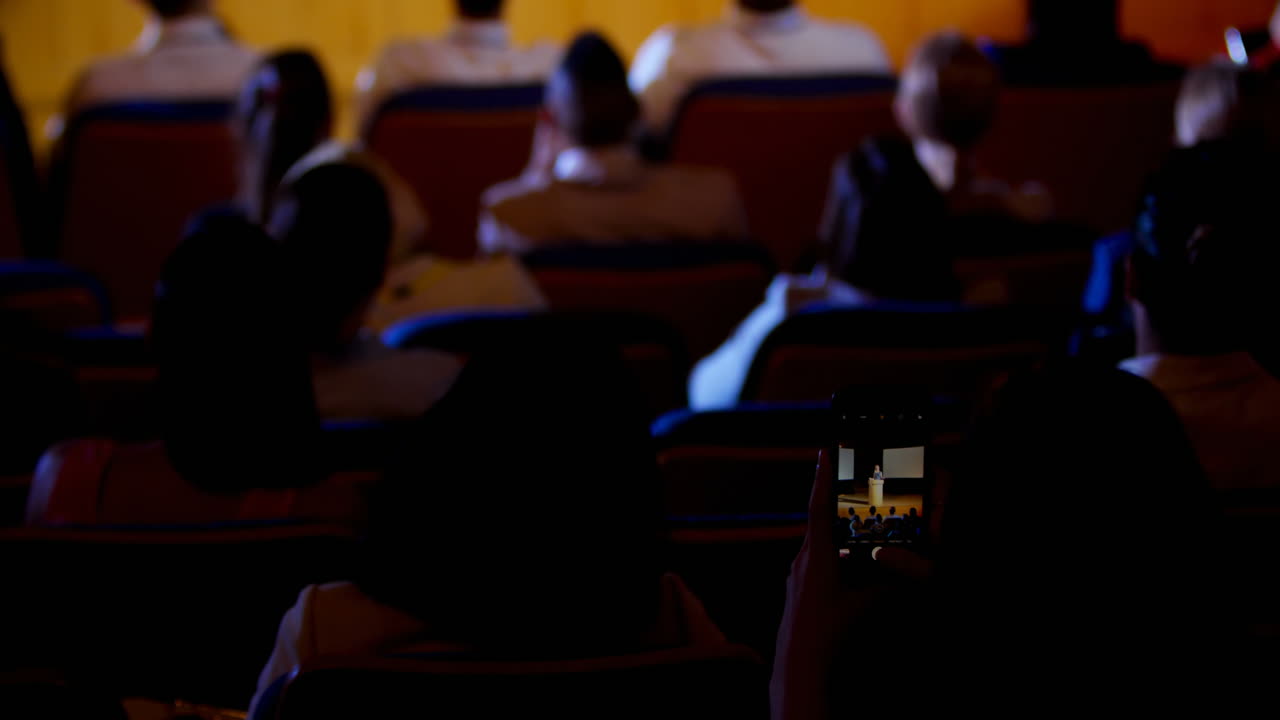 mujer de negocios grabando una conferencia durante un seminario de negocios en el auditorio 4k