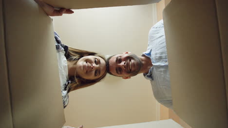 couple excitedly opening moving boxes
