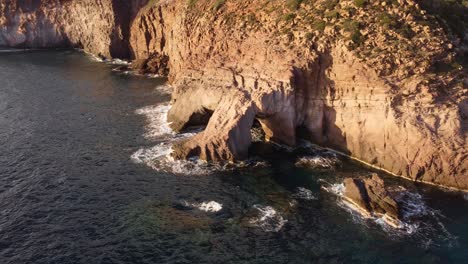 Astonishing-aerial-view-of-rugged-coastline-in-South-Sardinia,-golden-hour