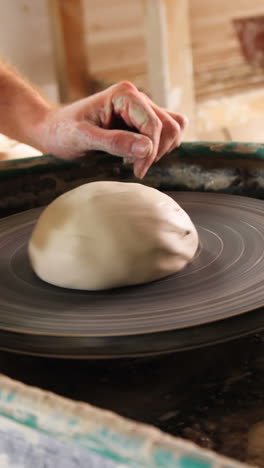 mid section of potter making pot