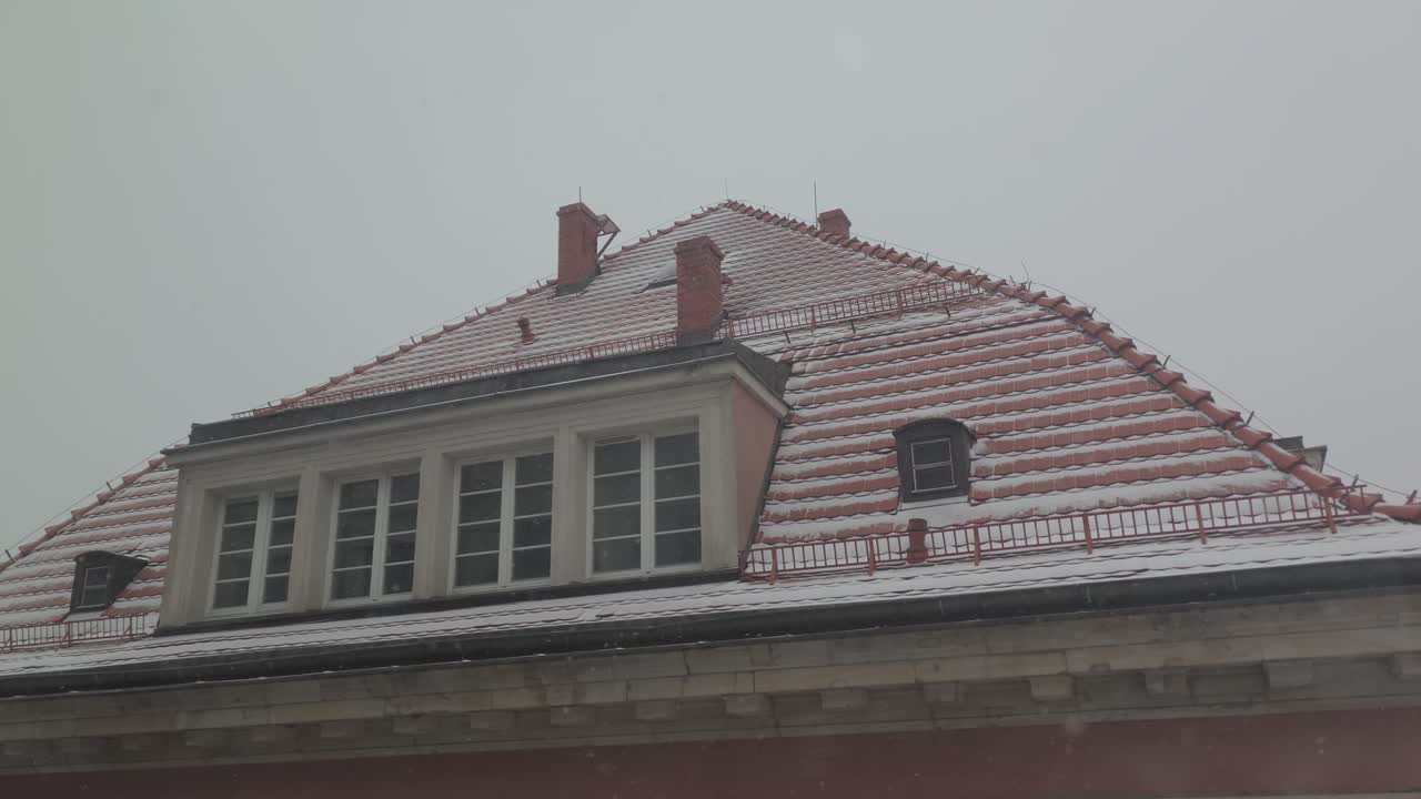 Snow Slowly Covering Red Tiles Rooftop Of A Building Snowfall In Wroclaw