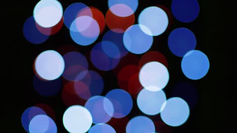 multicolored blinking bokeh on a black background.