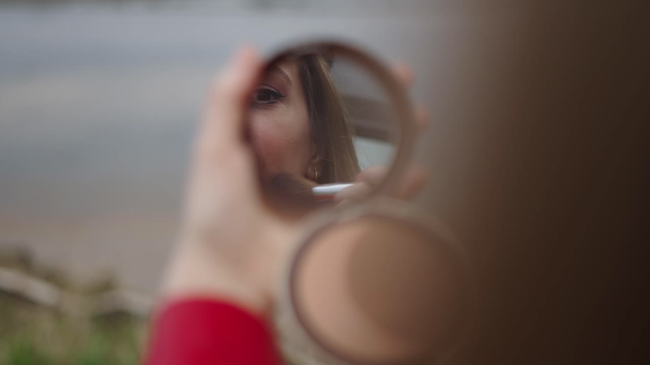 Woman Applying Makeup Outdoors