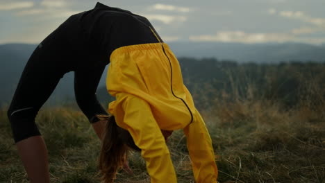 Woman-performing-bridge-yoga-pose.-Athletic-girl-stretching-in-mountains