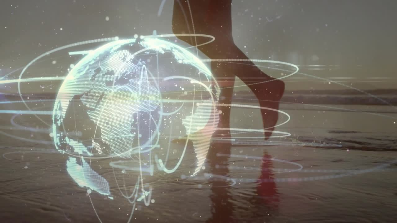 Woman's legs stepping onto wet sand activating rotating globe with orbit rings for tech demo
