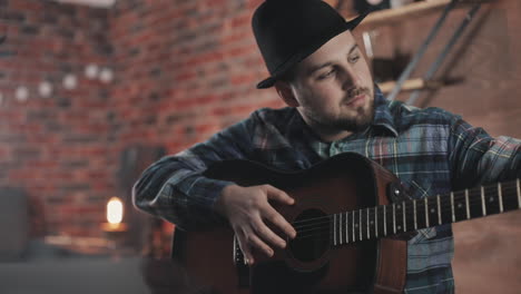 porträt eines jungen musikers, der zu hause gitarre spielt