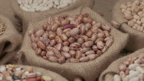 dry borlotti beans falling on jute bowl at slow motion