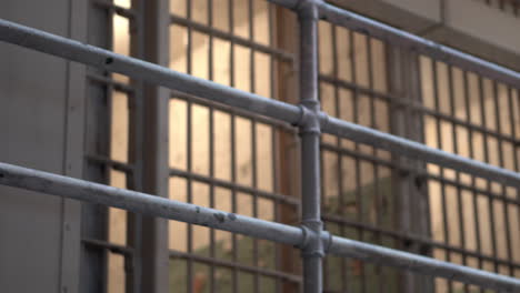 alcatraz prison detail, metal bars on fence and prison cell on upper lever in block d