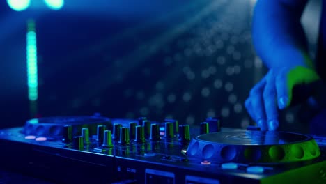 dj mixing music on a turntable at a nightclub
