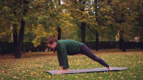 woman practicing yoga in an autumn park