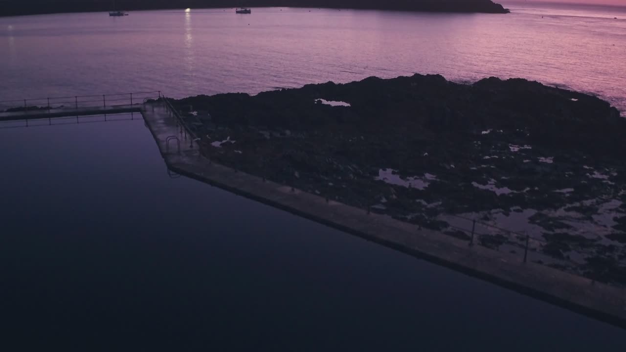 Guernsey tidal bathing pools and Cornet Castle at sunrise, Channel Islands, UK. Aerial drone view