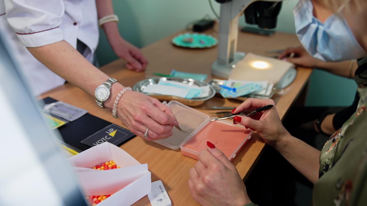 Ophthalmology professor showing the sample to a student. Future ophthalmic surgeon's practice. Close up.