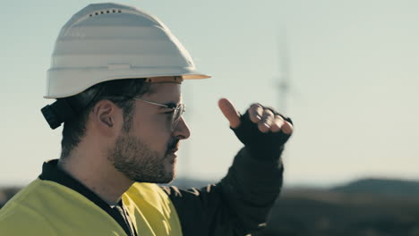 Renewable-energy-engineer-inspects-wind-turbines-on-a-sunny-day,-ensuring-a-sustainable-future-for-our-planet