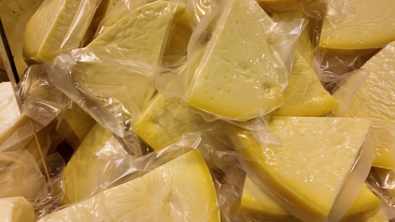 Assortment of Vacuum Sealed Cheese Wedges and Blocks