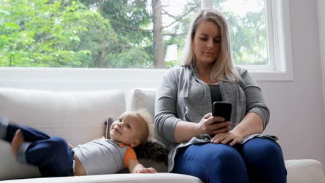 mother using mobile phone in living room 4k