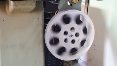 large bobbin with ending film reel turned by old cinema tool