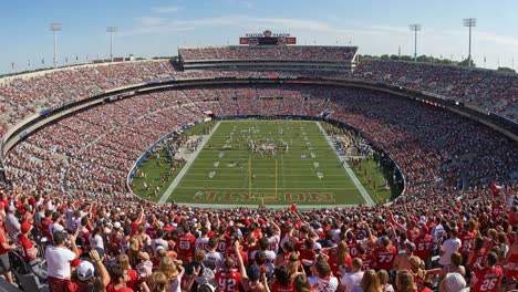 a thrilling college football game at glistening stadium with enthusiastic fans cheering for their teams in a vibrant atmosphere capturing the essence of sportsmanship