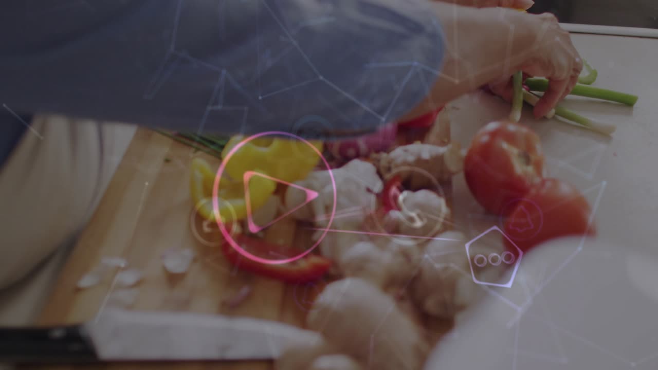 Senior woman slicing ginger root, activating digital icons and chopping peppers for recipe prep