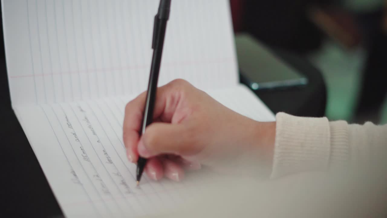 Person writing notes on paper!