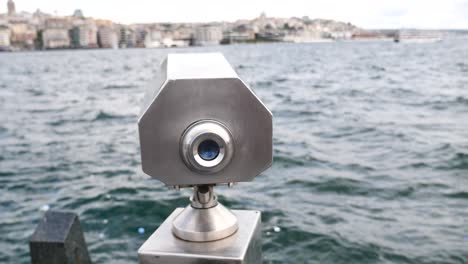 a telescope overlooking the sea in a city