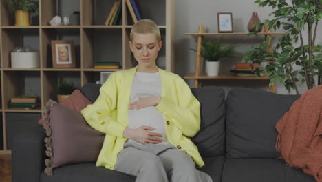 pregnant woman sitting on sofa