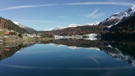 forward and up flight over davos lake switzerland with magnificent water reflections