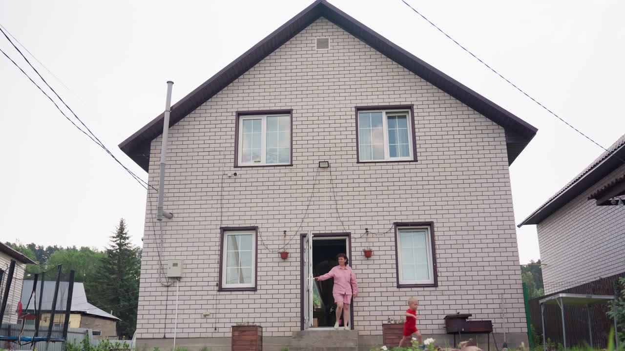 Children In Bright Attire Gather Outdoors, Brightly Clothed Children And Women Enjoy Outdoor Fun, Children Dressed In Vivid Clothing And Woman Engage In Joyful Outdoor Activities At House Entrance