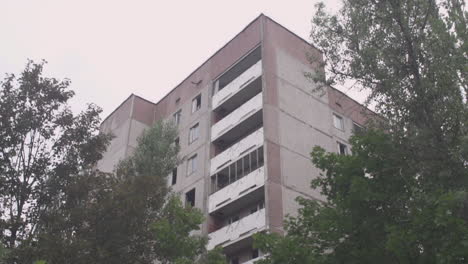 abandoned and overgrown apartment building in chernobyl exclusion zone