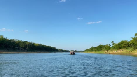 engine boat sailing through surma river in bangladesh, side view