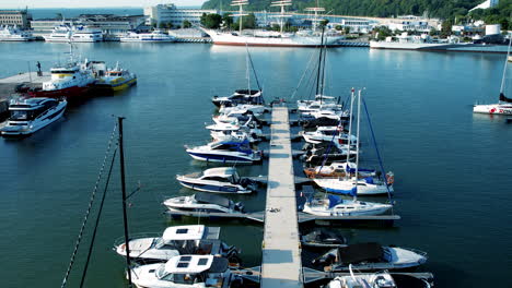 Marina-with-arrayed-boats-and-ships,-clear-blue-waters