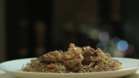 Panning-Shot-Of-A-Filipino-Style-Noodle-With-Beef-and-Shrimp-Toppings