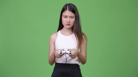 young beautiful asian businesswoman playing games