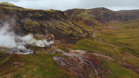 aerial of mountain landscape with geothermal hot springs in hveragerði, iceland