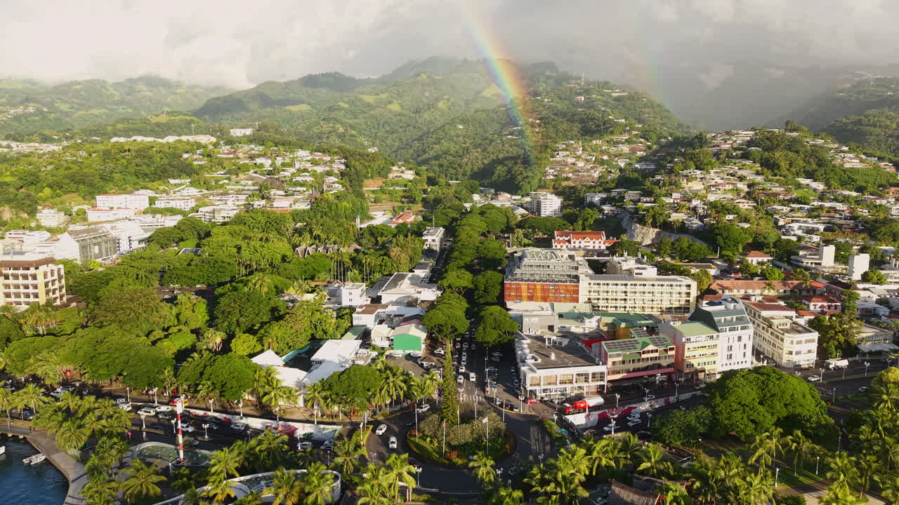 Papeete, Tahiti Island, French Polynesia. Drone Shot of City Traffic and Rainbow Above Hills