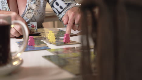 moving figures or characters of board game on table, closeup view