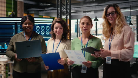 vertical video portrait of diverse group of businesswomen collaborating on report writing