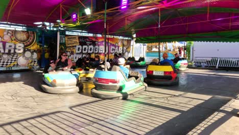 people enjoying bumper cars at a fun fair