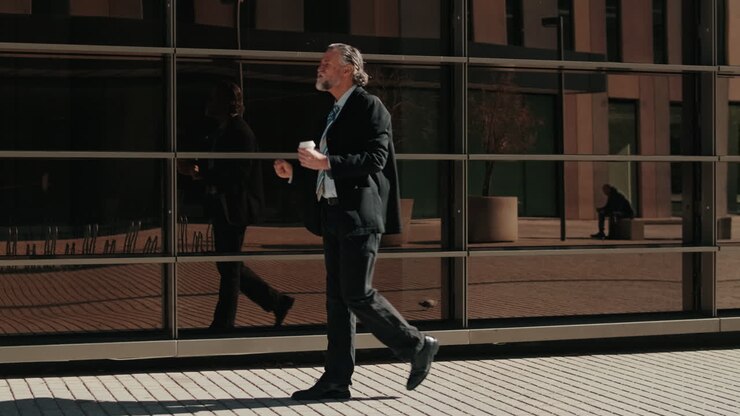 Businessman Walking Outside Office Building