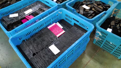 sorting and recycling of broken glass pieces in blue plastic crates
