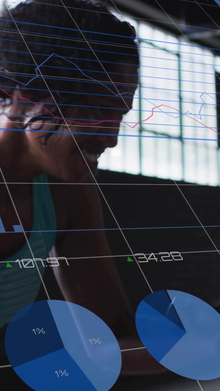 Vertical video: Woman pulling gym handle, driving blue charts updating and tracking fitness metrics