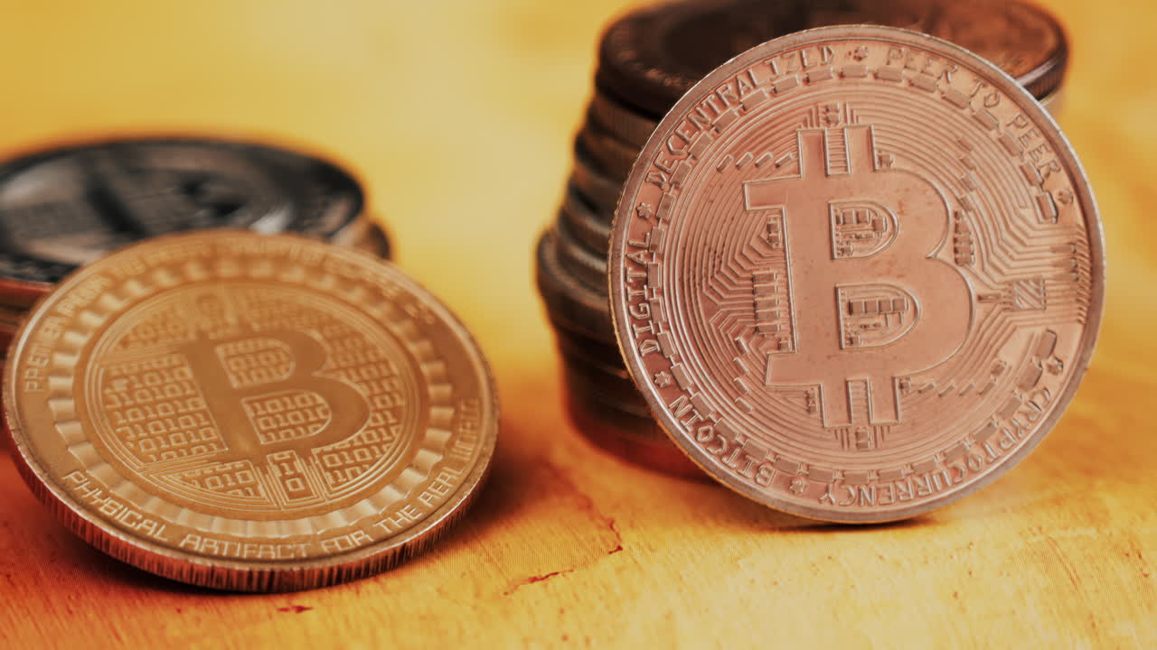 Close up of shiny physical Bitcoin coins stacked on a table